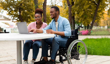 Picture of a two people with a laptop Picture of a two people with a laptop